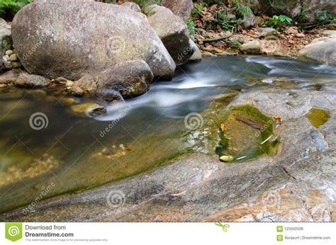 Waterfall With Stone Of Green Moss In Rain Forest