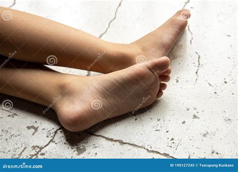 Children`s Bare Feet Child`s Bare Feet On The Cement Floor Stock Image