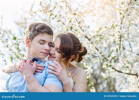 Bride Embraces Groom In The Blossoming Spring Garden Stock Image Image Of Emotional Dress