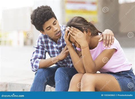 Young Guy Comforting His Sad Girlfriend That Crying On Public Stock
