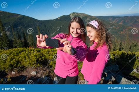 Two Happy Female Hikers Smiling And Taking Selfie Photo Stock Photo