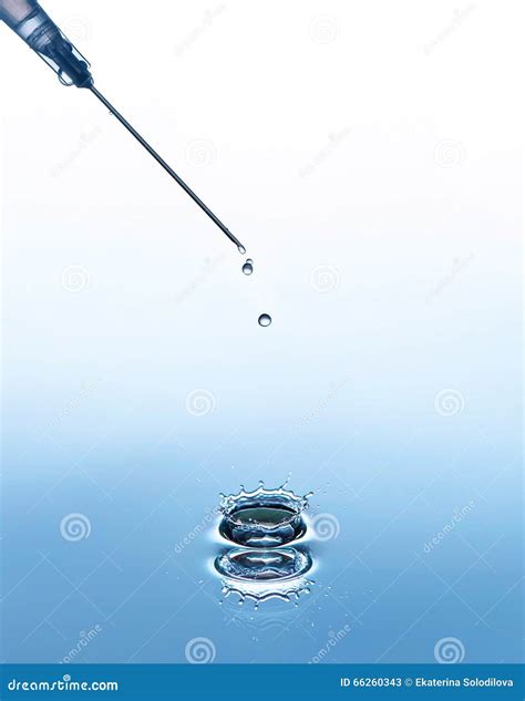 The Syringe Needle On The Blue Water Background With Splash And Drops