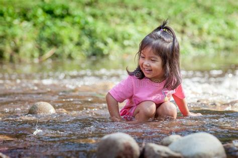 Child Little Girl Having Fun To Play In Waterfall Stock Photo Image