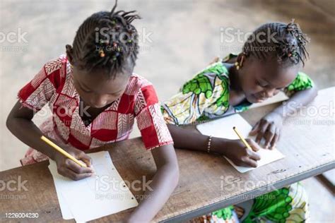 Two Beautiful African Children Sitting In Classroom In Bamako Mali