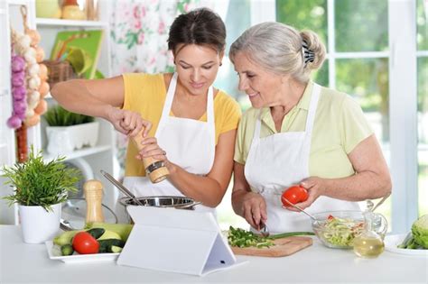 Premium Photo Mother And Daughter Cooking Together