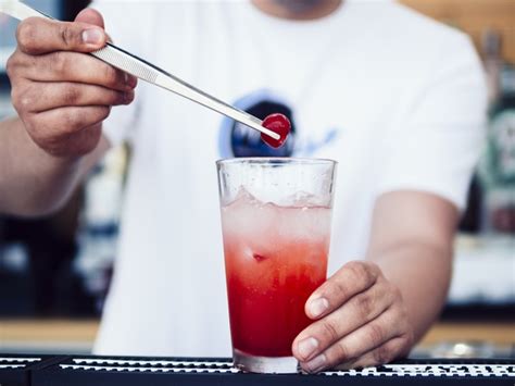 Free Male Bartender Decorating Drink With Cherry Free Photo Nohatcc