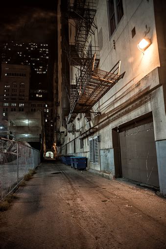 Dark And Eerie Downtown Urban City Alley At Night Stock Photo