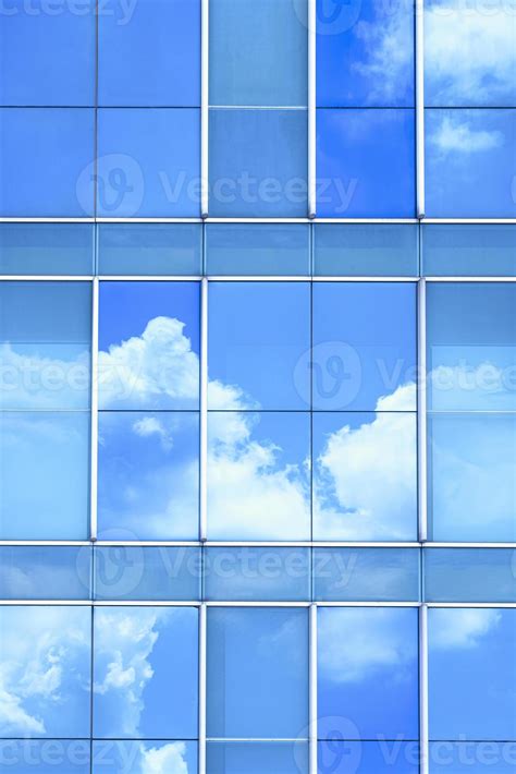 Cloud And Blue Sky Reflection On Surface Of Glass Modern Building Wall