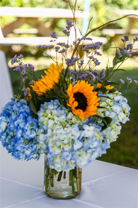 From red to purple to rainbow flowers, search wedding flowers by color and quickly see what your choices are. Blue Hydrangea and Sunflower Centerpieces