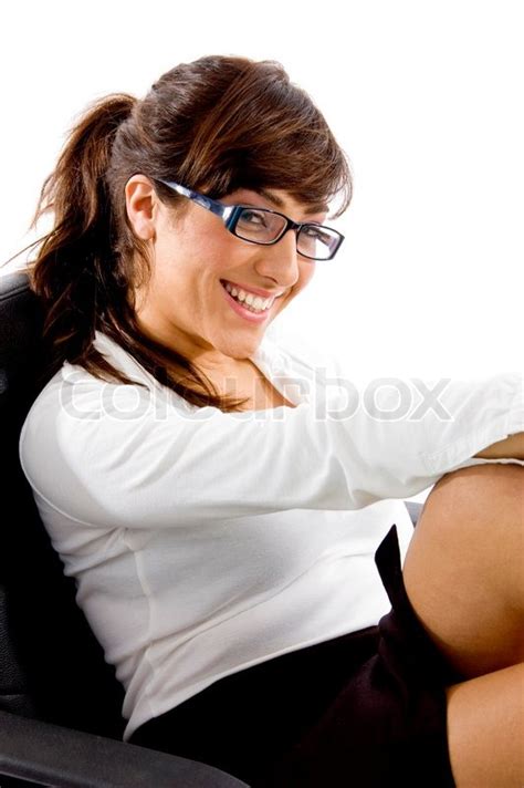 Side View Of Smiling Woman Sitting On Chair Stock Photo Colourbox