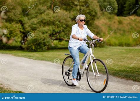 Happy Senior Woman Riding Bicycle At Summer Park Stock Photo Image Of Ride Cycle