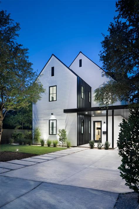 Modern White Farmhouse Exterior With Dormer Roof And Black Metal Accent ...