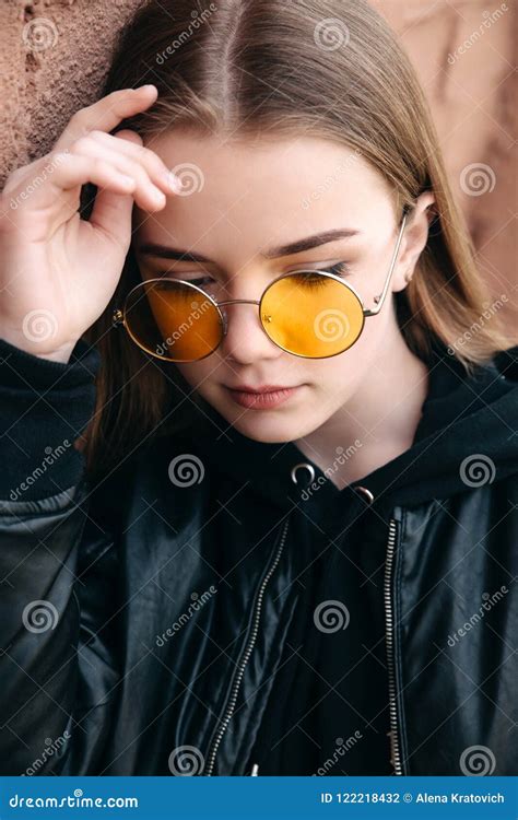 Beautiful Fashionable Kid Girl In Yellow Sunglasses In City Street