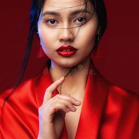 asian beauty woman with red lips make up chinese beautiful model face portrait over red