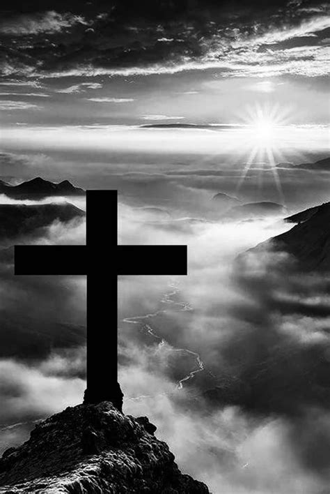 Download A Stark And Emotive Black Cross Set Against A White Background