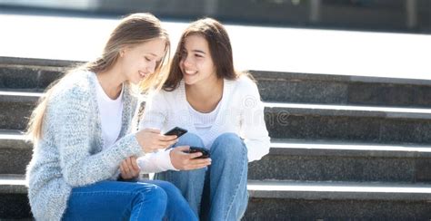 Two Girls Talking Together In The Street Stock Photo Image Of Person