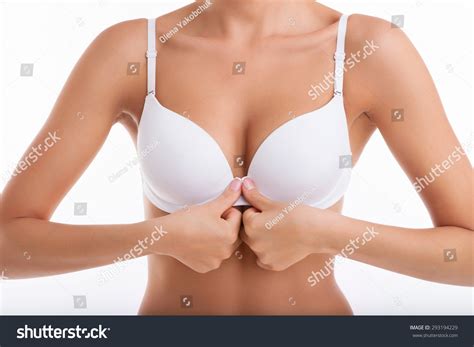 Close Up Of Breast Of Fit Woman Unbuttoning Her White Bra In Front Of