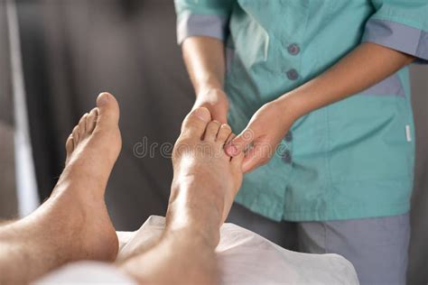 Man Having Foot Massage In Medical Office Close Up Photo Of A Spa Professional Having A Feet