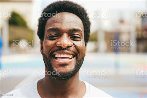 Happy African Man Smiling At Camera Inside Basketball Court Focus On