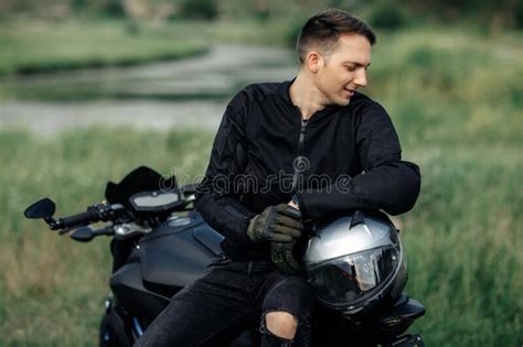 Photo Of Biker Sitting On Motorcycle In Sunset On The Country Road