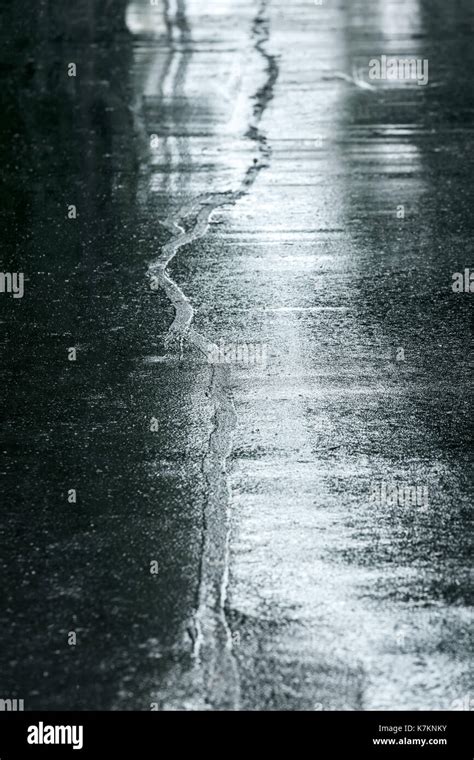 Wet Asphalt Sidewalk In Rainy Day Water Puddles On Street Road Surface