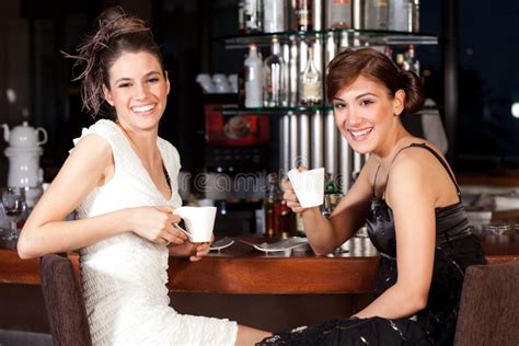 Two Beautiful Young Women Drinking Coffee At Bar Stock Photo Image Of