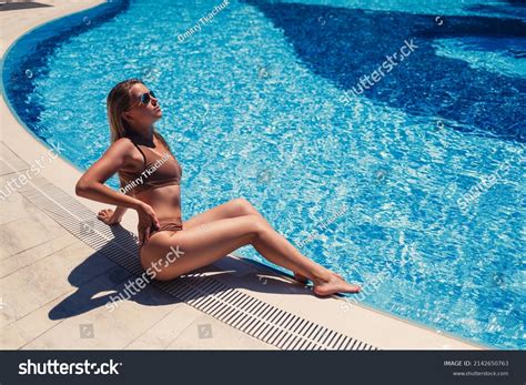 Beautiful Tanned Woman Relaxing By Pool Stock Photo