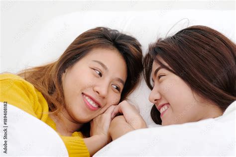 Lgbt Young Cute Asia Lesbians Lying And Smiling On White Bed Together