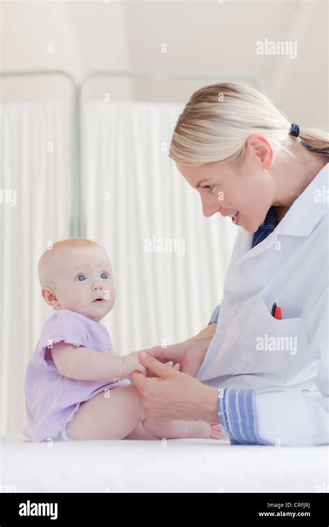 Doctor Examining Baby In Office Stock Photo Alamy