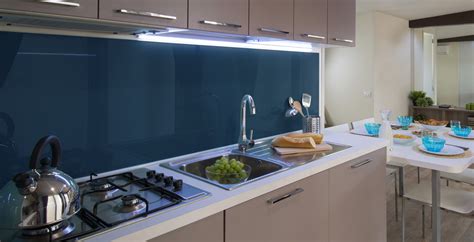 A simple design using white cabinets along with black countertop backsplash coveys a bold yet inexpensive and vibrant kitchen. Four Kitchen Backsplashes in the Hottest Fall Colors - Refresh