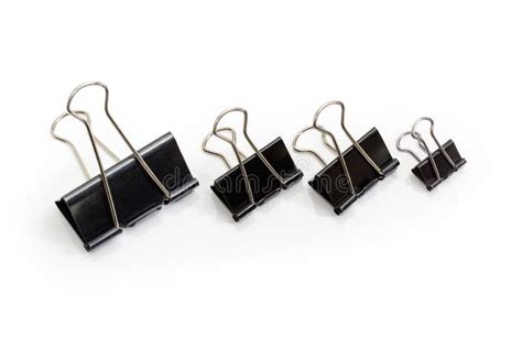 Several Binder Clips Different Sizes On A White Background Stock Photo