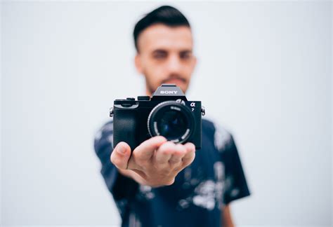 Person Holding Sony Dslr Camera · Free Stock Photo