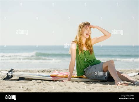 Woman Sitting On Surfboard Stock Photo Alamy