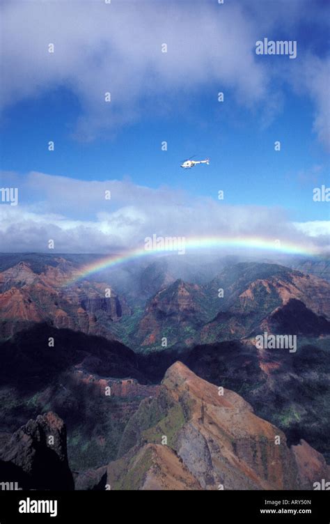 Helicopter Flying Over Waimea Canyon With Rainbow Island Of Kauai