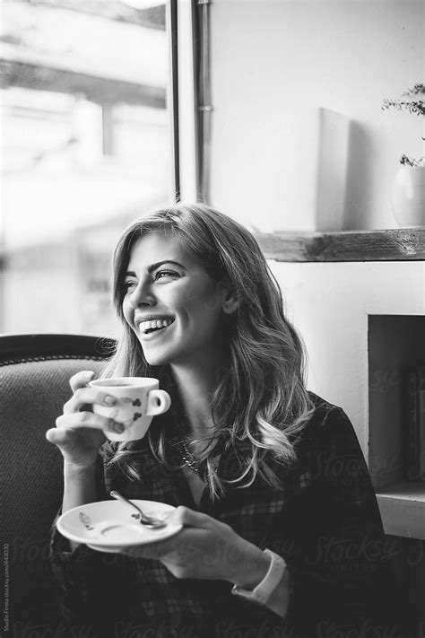 Smiling Young Woman Drinking Coffee By Stocksy Contributor Studio