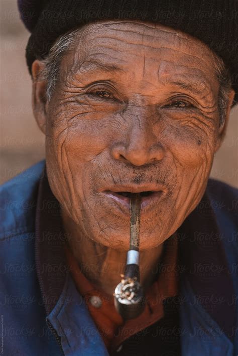 Old Man Smoking Pipe By Stocksy Contributor Chalit Saphaphak Stocksy