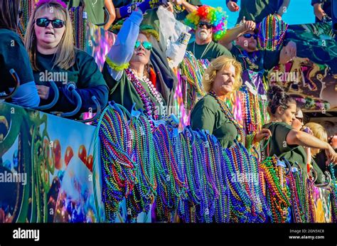People Throw Beads From A Mardi Gras Float During The Joe Cain Day