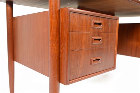 It has some scratches and crazing from age and some discoloration from the heat. DANISH MODERN FLOATING TOP TEAK DESK • Mid Century Mobler