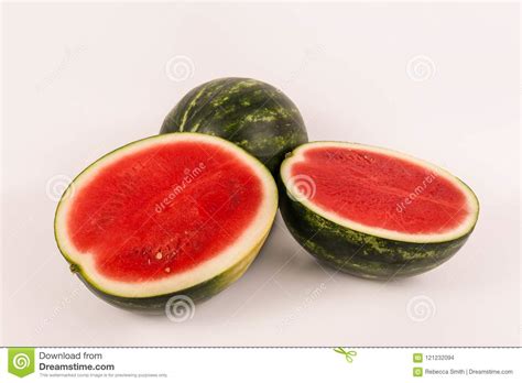 One Whole And Two Halved Red Seedless Organic Watermelons Stock Photo