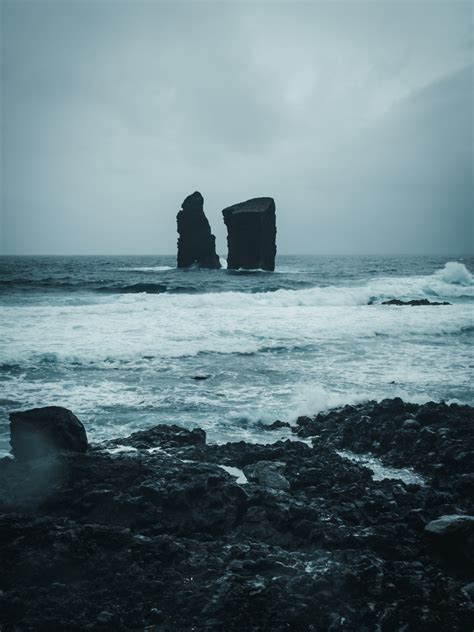 Black Rocks On Ocean · Free Stock Photo