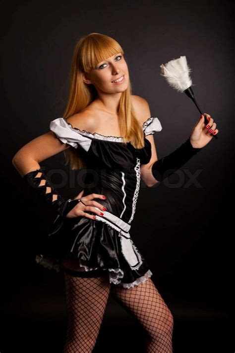 Beautiful Caucasian Woman Dressed In A French Maid Costume Isolated On A Black Background