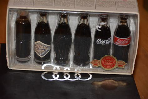 Footballs and big macs are certainly part of life for lots of people; Collection of 6x Coca-Cola miniature bottles - 100 years - Catawiki