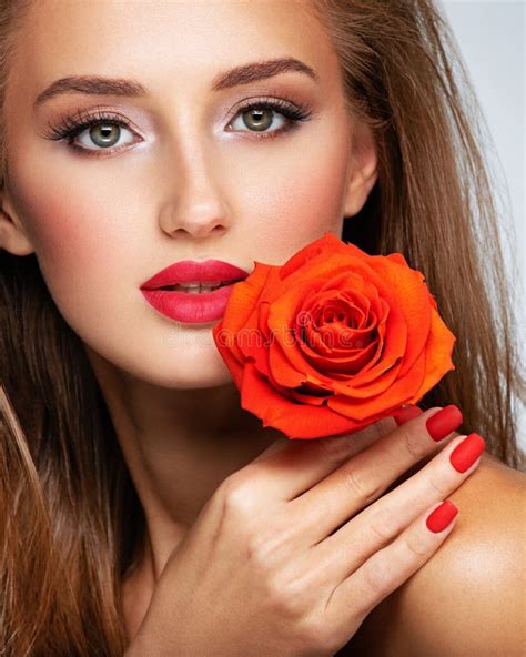 Beautiful Young Woman With A Red Flower In Hand Near Face Portrait Of