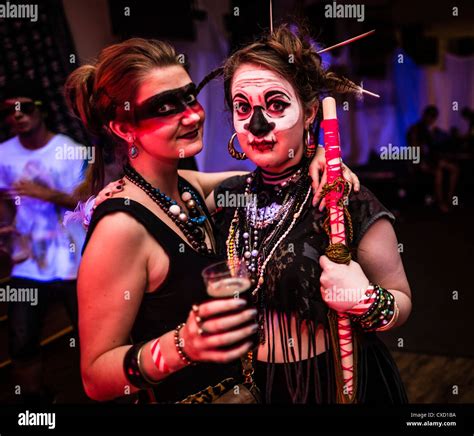 Two Young Women At A Neon Voodoo Tribal Themed Rave Dance Party