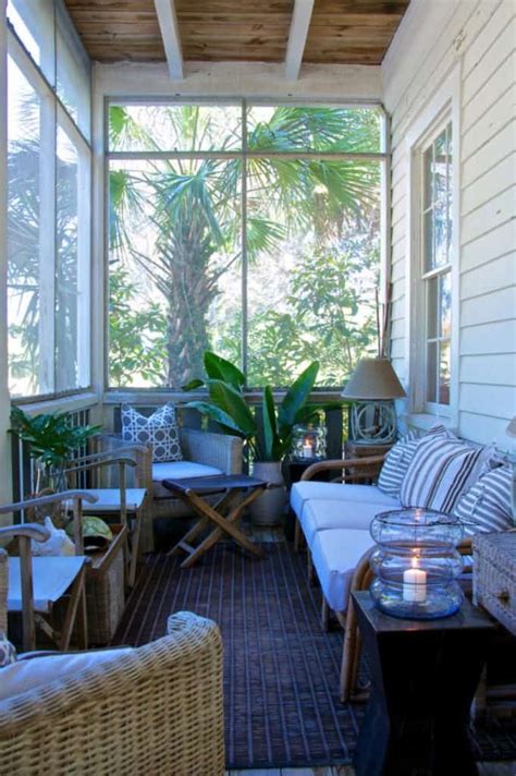 A Porch With Wicker Furniture And Potted Plants