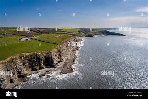 An Aerial View Of The Beach And Cliffs At Dunraven Bay At Southerndown
