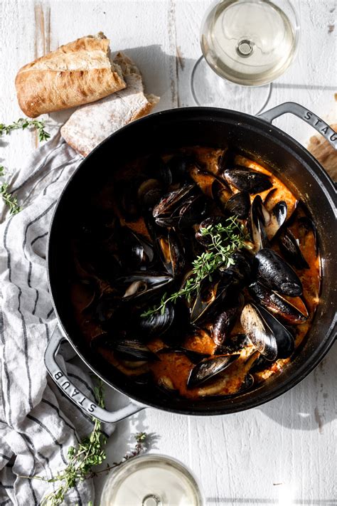 steamed mussels in saffron chorizo broth cooking with cocktail rings