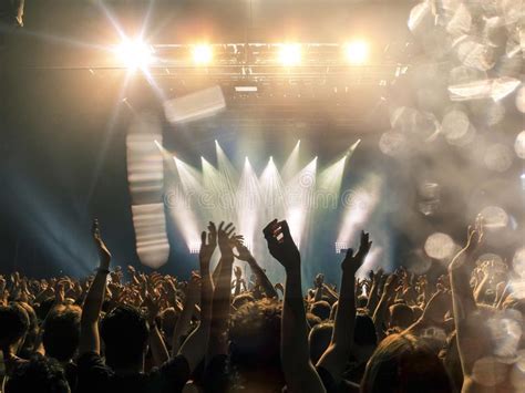 Concert Hall With A Wide Crowd Clapping In Front Of A Stage Stock Image