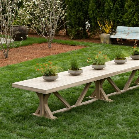 A Wooden Bench With Three Planters On It