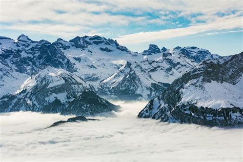 Summits Of The Alps Rising From Sea Of Fog In Winter Stock Photo
